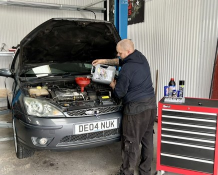 mechanic completing engine service on Ford Focus ST170