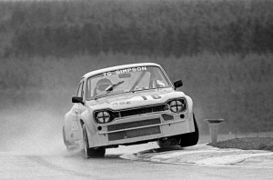 Mk1 Escort racing and clipping the kerb at Knockhill
